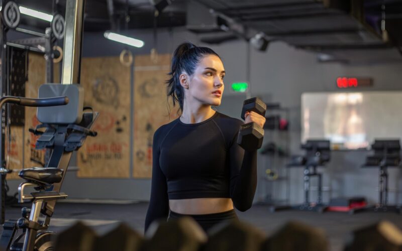 gym-fitness-woman-working-gym-exercises-girl-gym-with-dumbbells_169016-63618